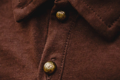 Brown polo detail with gold buttons