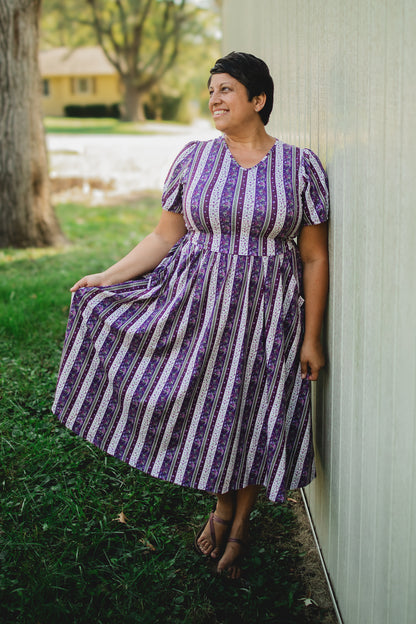 woman wearing a modest nursing purple and white striped dress