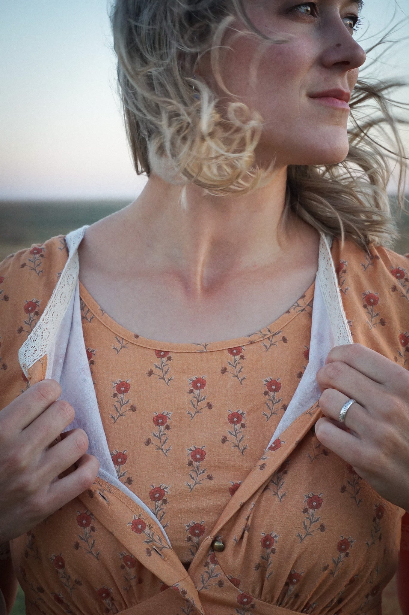 Woman in modest nursing dress floral background
