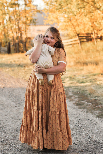 Young girl in long dress with teddy bear