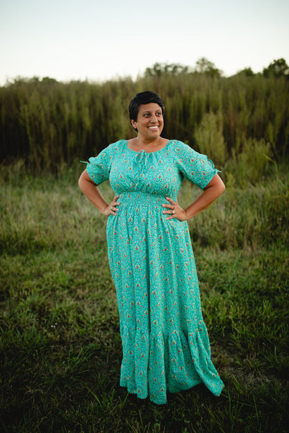 Woman in modest nursing teal dress in field