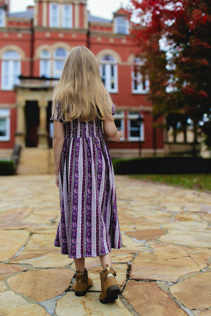 Girl in modest purple dress outdoors