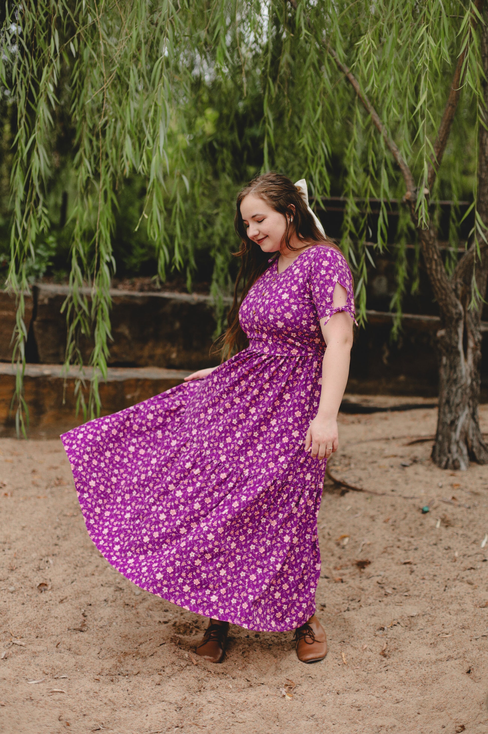 Woman in modest nursing purple floral dress outdoors