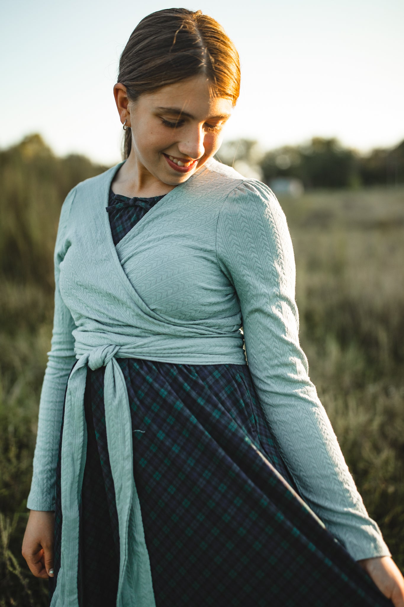 Woman in modest nursing wrap dress with plaid skirt