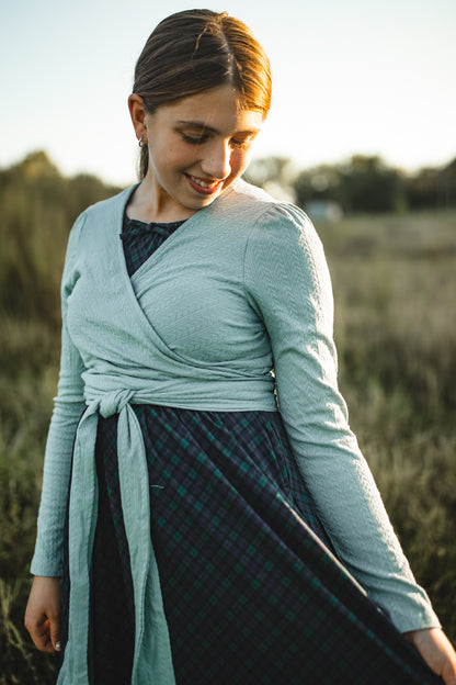 Woman in modest nursing wrap dress with plaid skirt