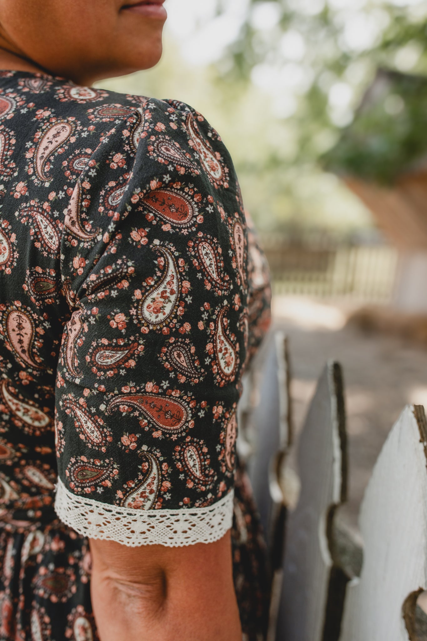 woman wearing a modest nursing black patterned dress
