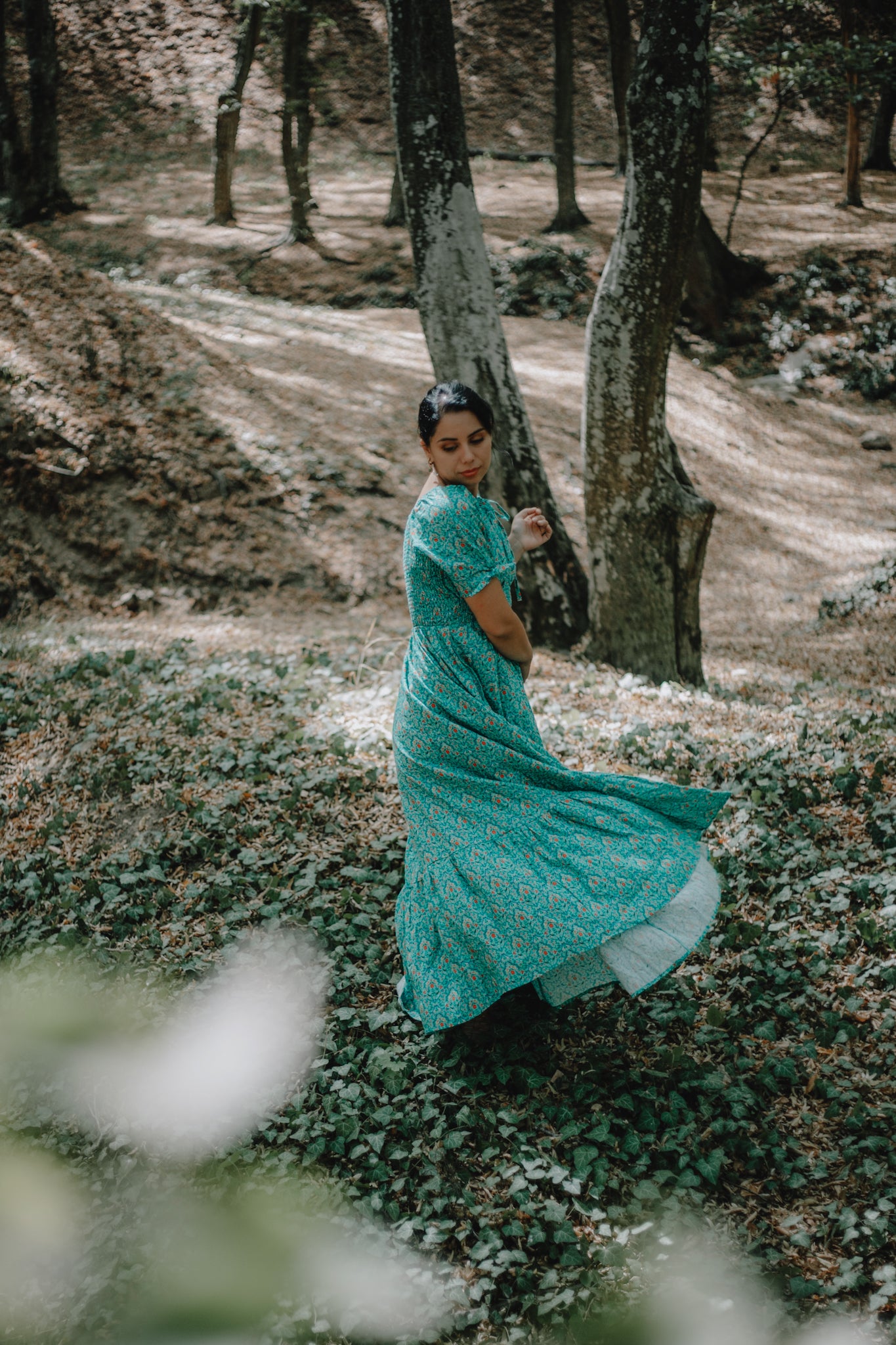 Woman in modest nursing teal dress outdoors