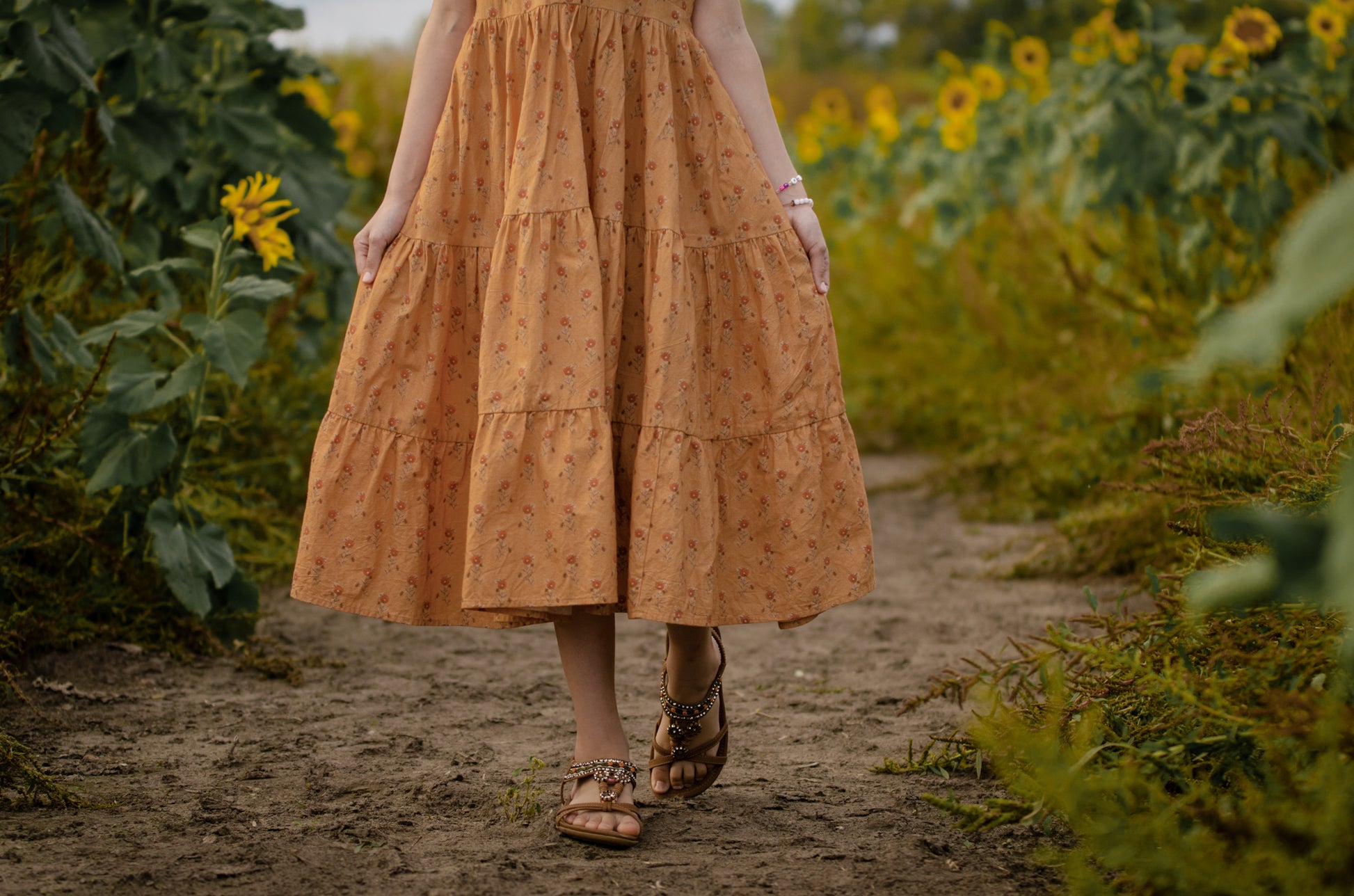 Woman in modest nursing dress in sunflower field