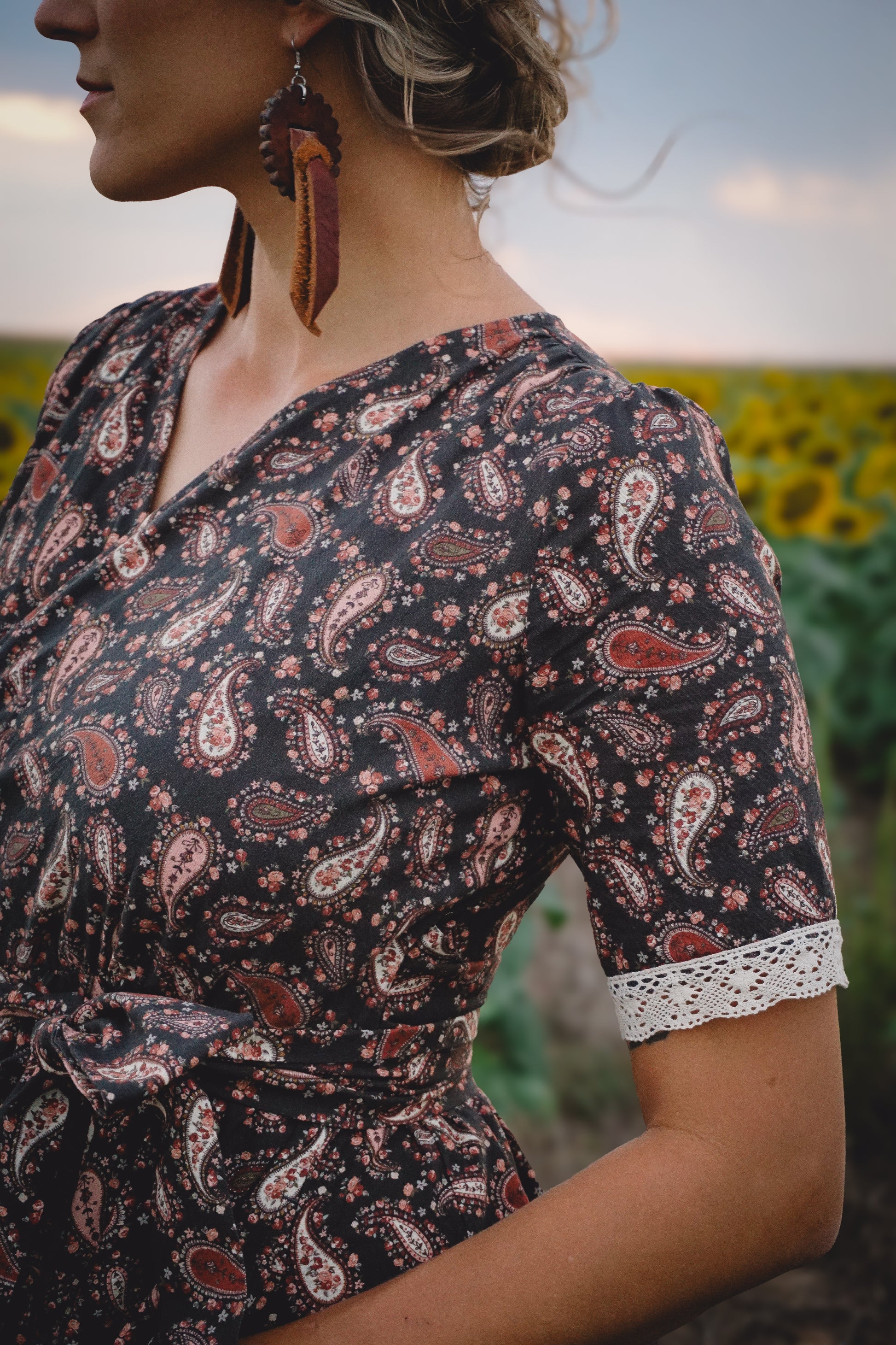 Woman in modest nursing dress in sunflower field
