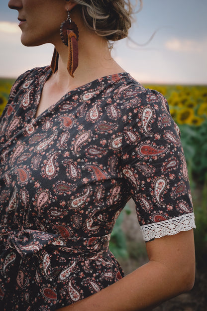 Woman in modest nursing dress in sunflower field