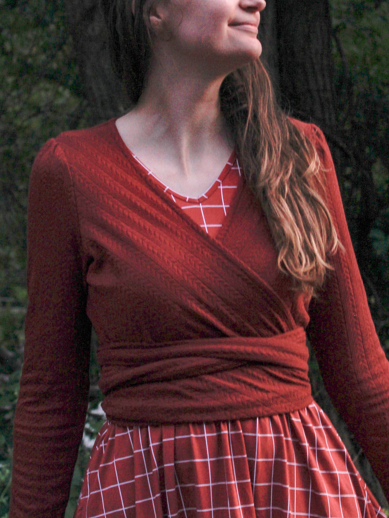 Woman in modest nursing red plaid wrap dress