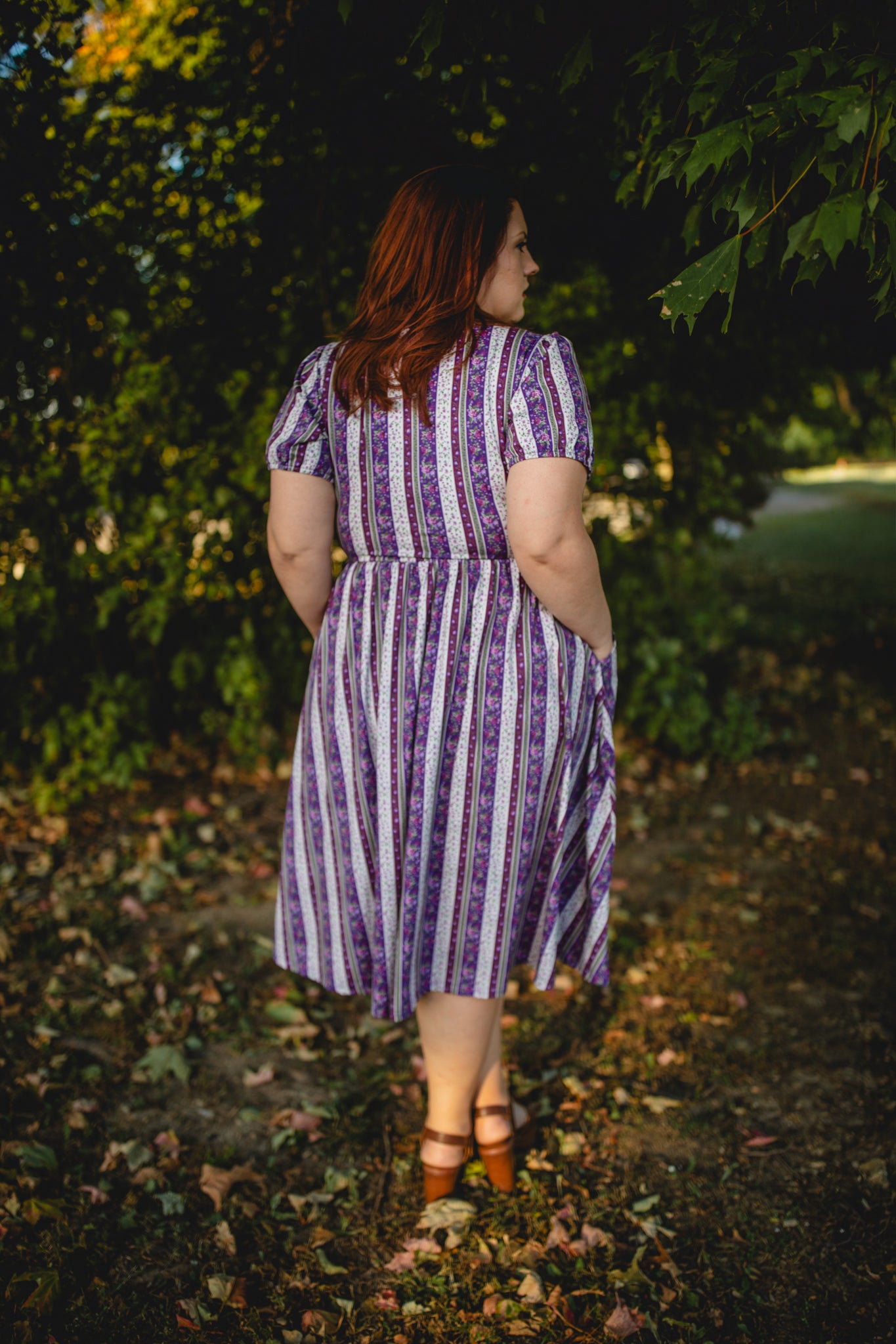 woman wearing a modest nursing purple and white striped dress