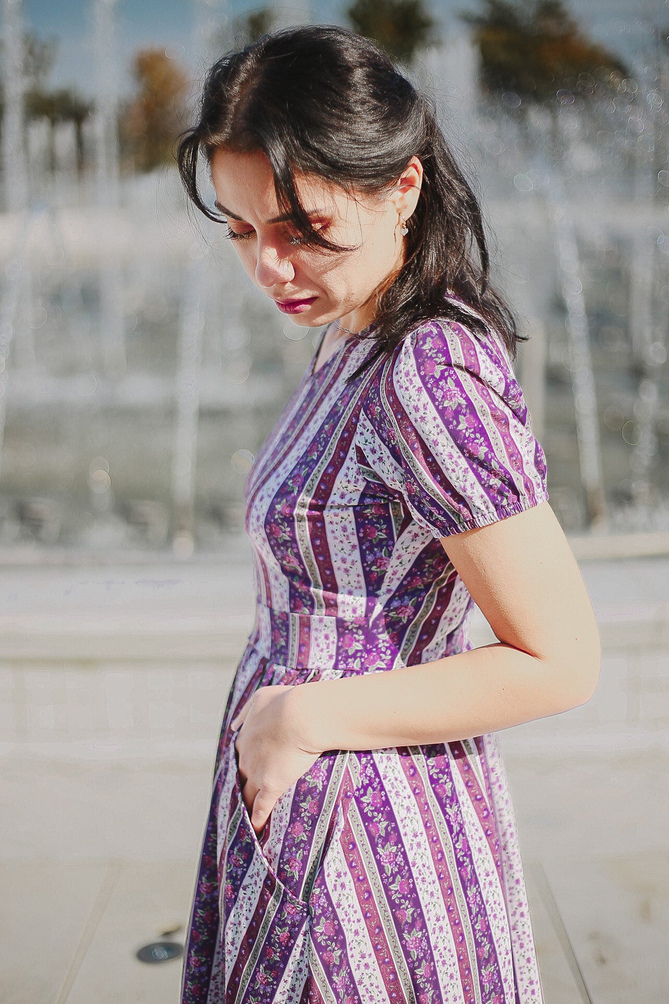 woman wearing a modest nursing purple and white striped dress