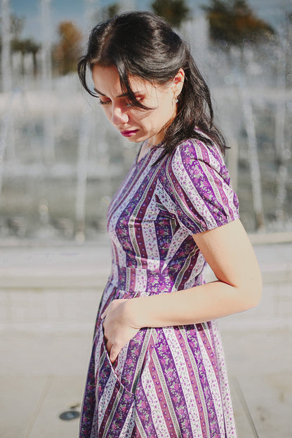 woman wearing a modest nursing purple and white striped dress
