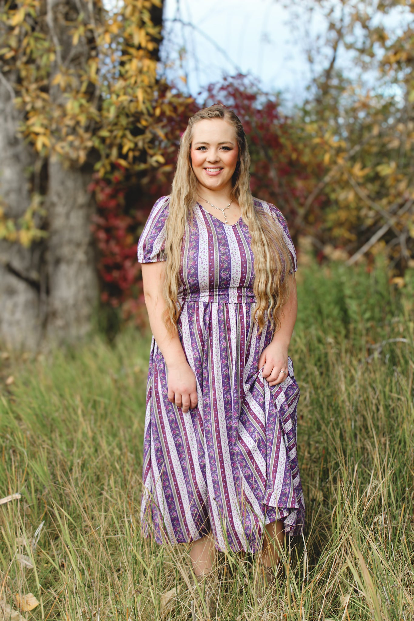 woman wearing a modest nursing purple and white striped dress