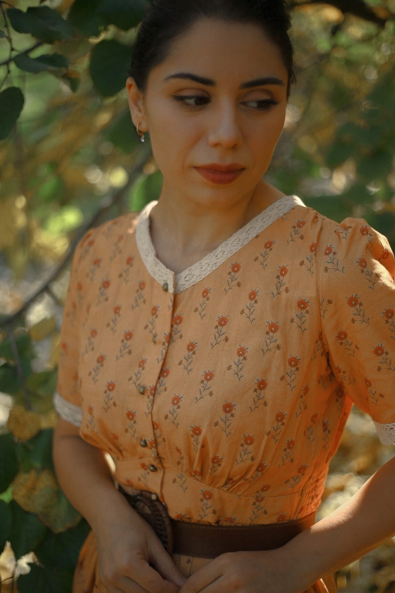 Woman in floral blouse green foliage