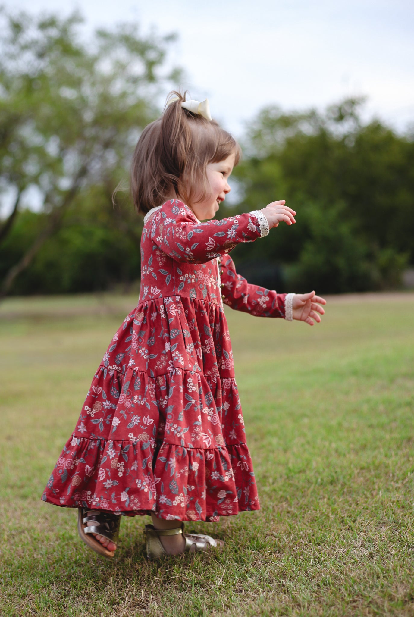 Girl in modest red floral dress outdoors