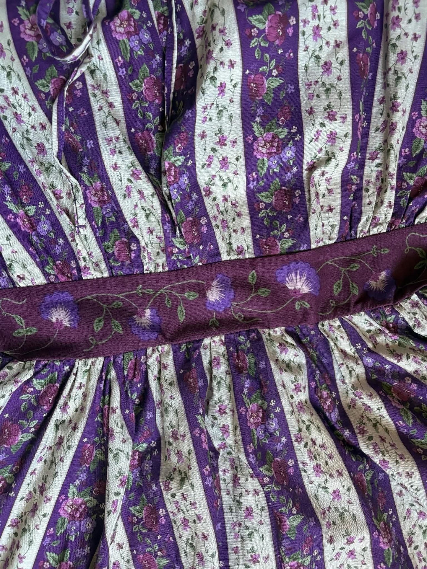Purple and white striped fabric with floral patterns