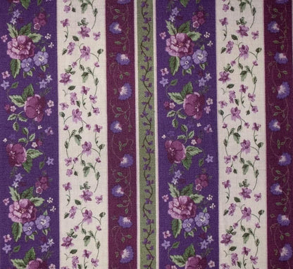 Striped fabric pattern with floral design in purple, green, and white.