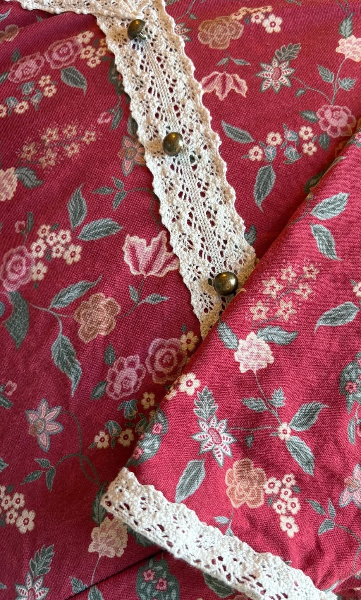 Red floral fabric with lace trim and buttons
